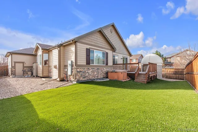 a view of a house with a yard and deck
