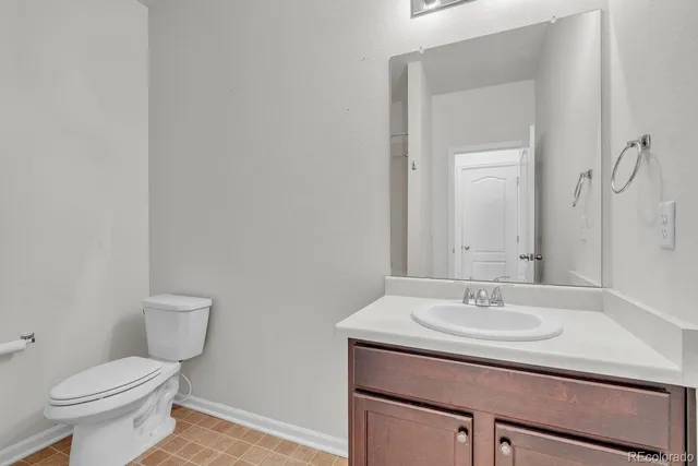 a bathroom with a sink toilet and a mirror