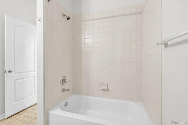 a white bath tub and shower