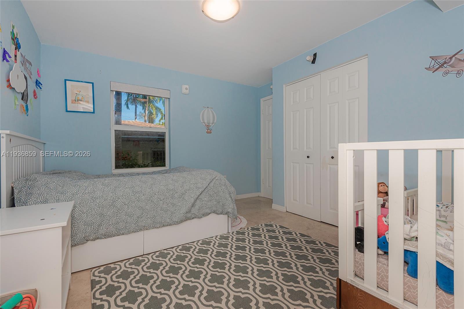 1005 8th Street, Unit 204 Miami Beach, FL 33139 - Photo 18 of 33 a bedroom with a bed and a window