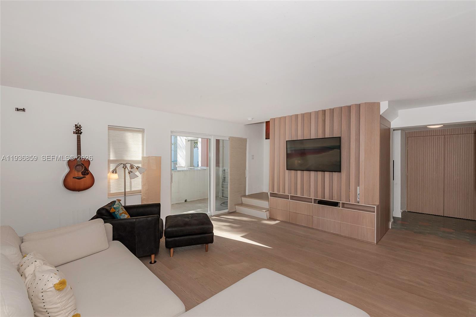 1005 8th Street, Unit 204 Miami Beach, FL 33139 - Photo 2 of 33 a living room with furniture and a flat screen tv