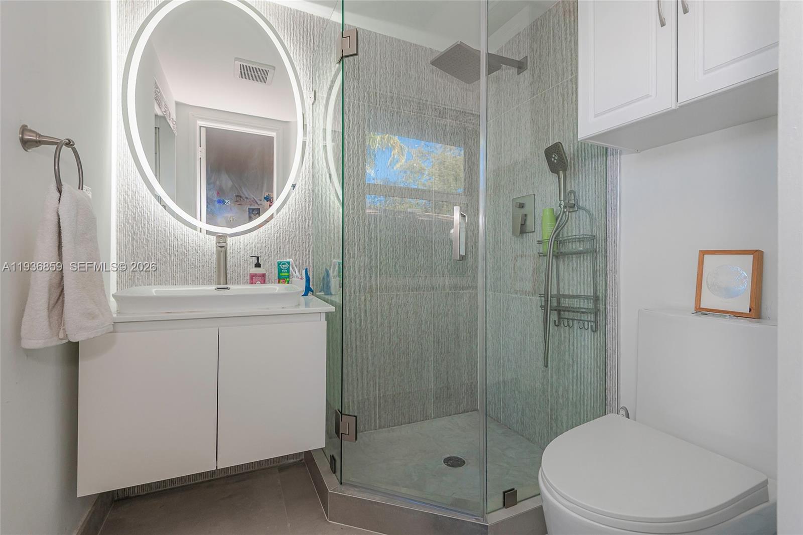 1005 8th Street, Unit 204 Miami Beach, FL 33139 - Photo 21 of 33 a bathroom with a toilet a sink and shower