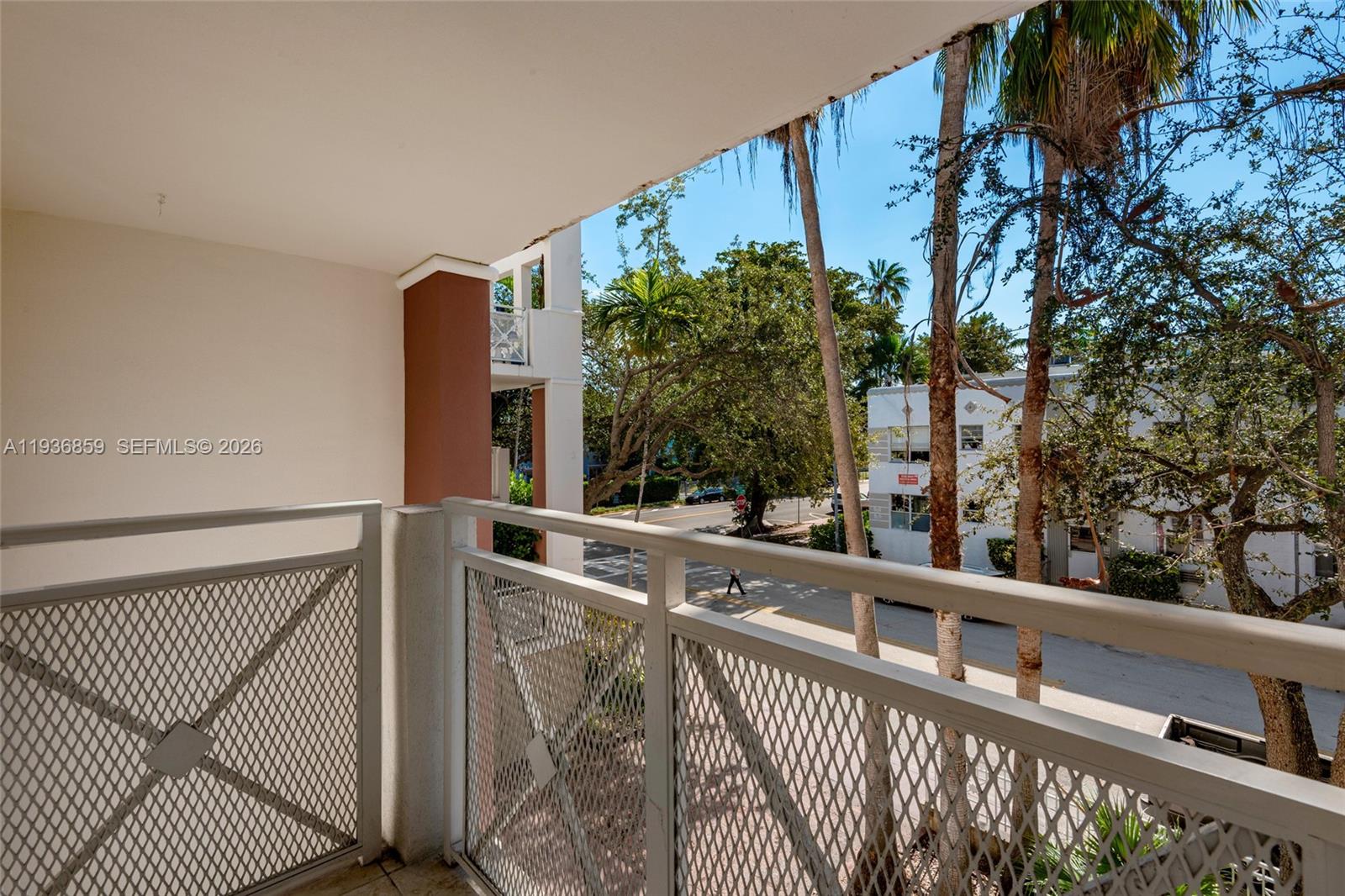 1005 8th Street, Unit 204 Miami Beach, FL 33139 - Photo 22 of 33 a view of a balcony with wooden fence and floor