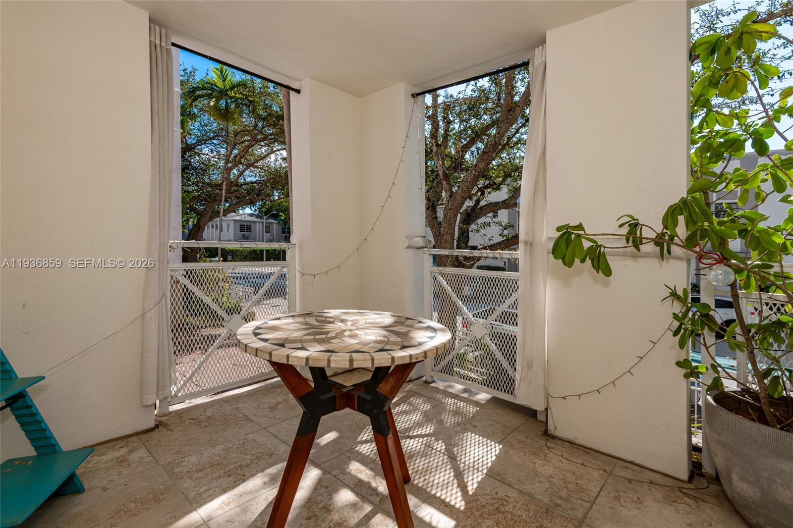 1005 8th Street, Unit 204 Miami Beach, FL 33139 - Photo 24 of 33 a view of a dining table and chairs in a patio