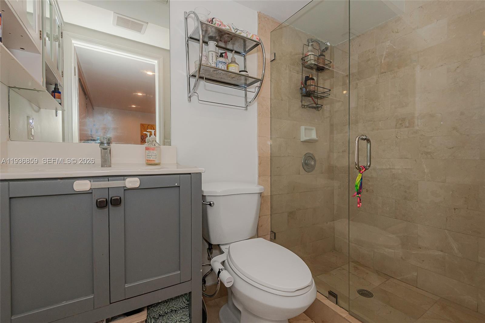 1005 8th Street, Unit 204 Miami Beach, FL 33139 - Photo 8 of 33 a bathroom with a shower a toilet and a sink