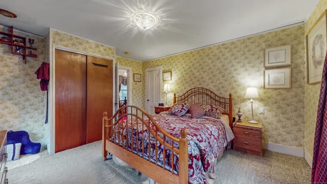 a bedroom with a bed and a mirror