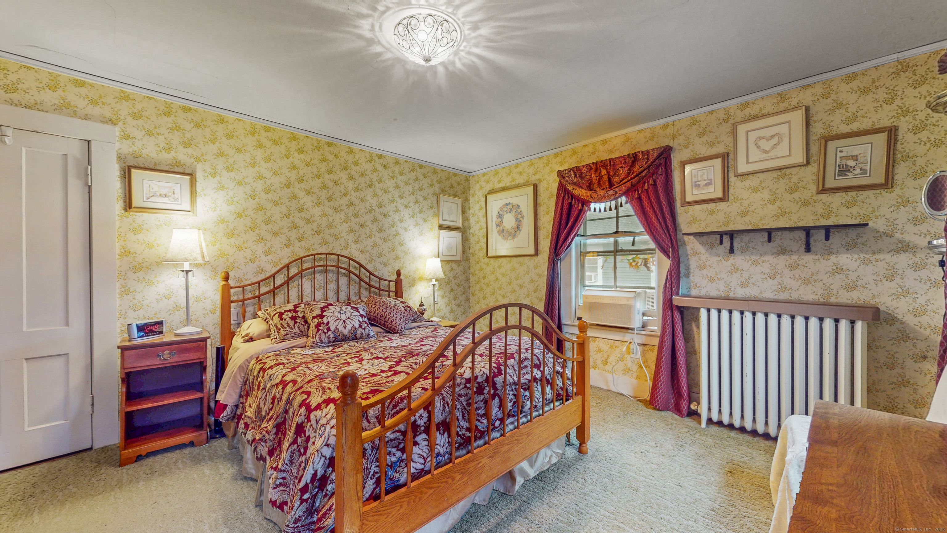 59 Elm Street Windsor Locks, CT 06096 - Photo 22 of 38 a bedroom with a bed and a painting on the wall