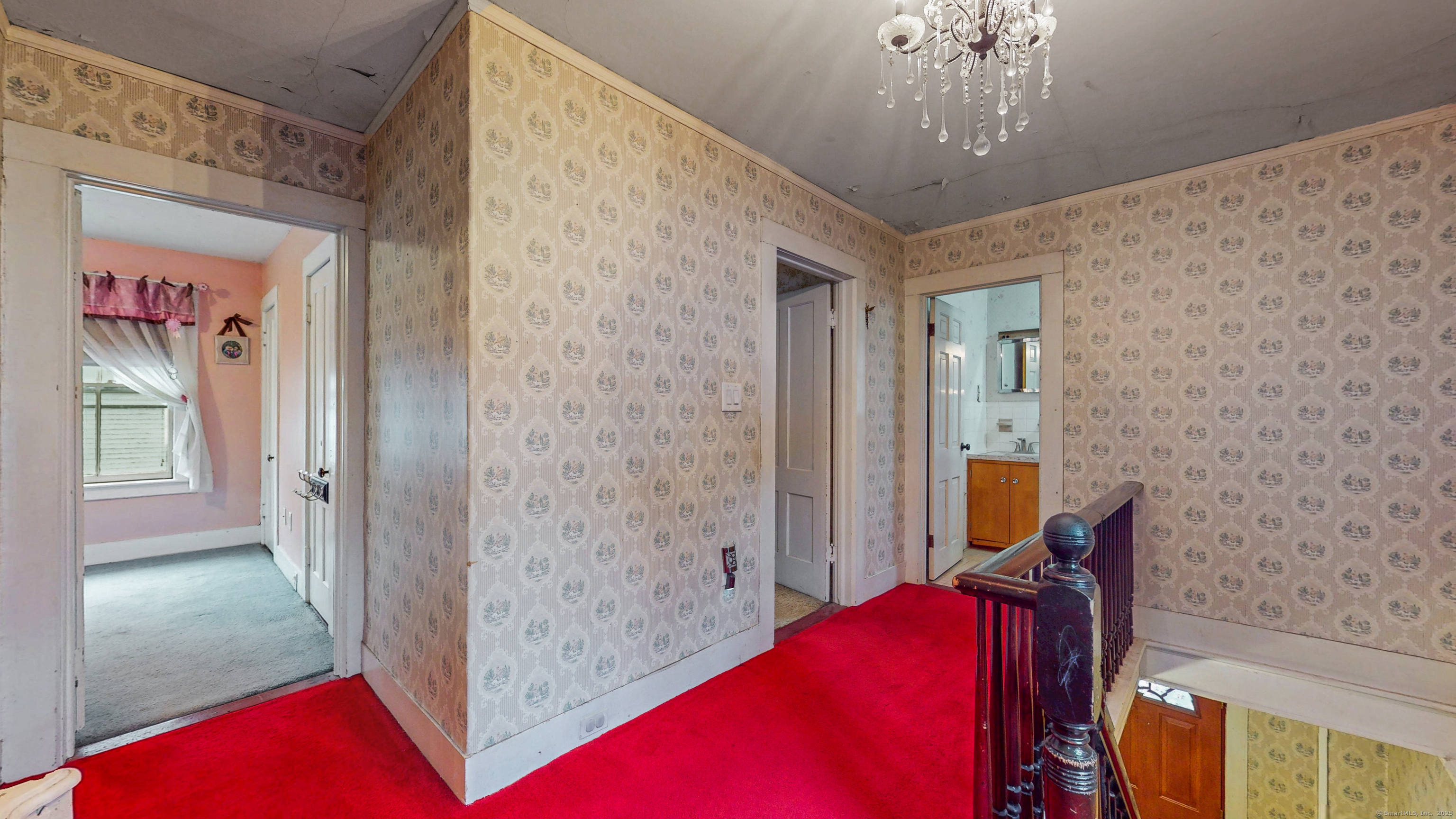 59 Elm Street Windsor Locks, CT 06096 - Photo 29 of 38 a bedroom with a bed and a chandelier