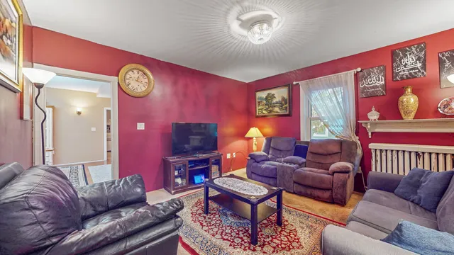 a living room with furniture a rug and a window