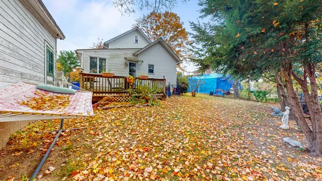 a view of a house with chairs next to a road