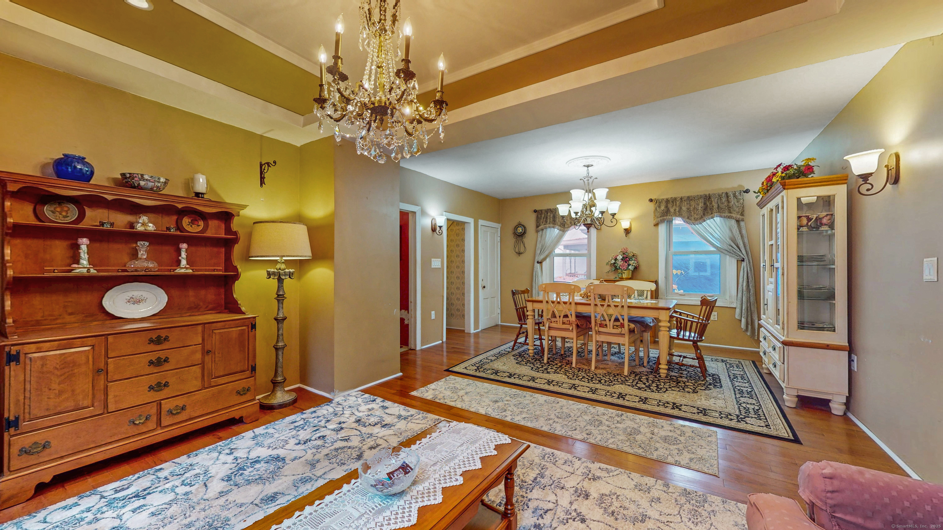 59 Elm Street Windsor Locks, CT 06096 - Photo 10 of 38 a dining room with chandelier and wooden floor