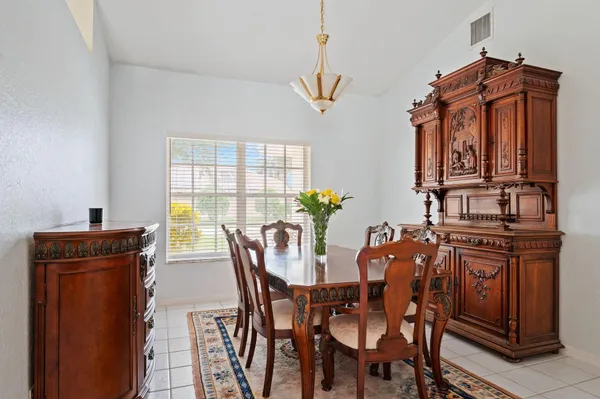 a view of a dining room with furniture and window
