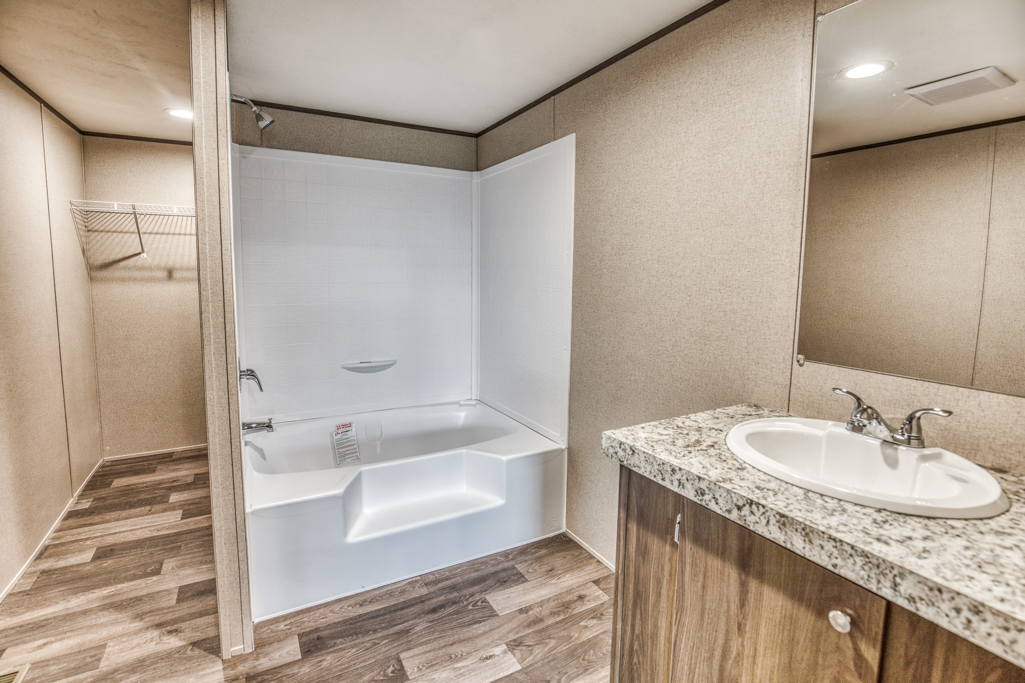 1001 Schmidt Road Waller, TX 77484 - Photo 12 of 28 a bathroom with a granite countertop sink and a mirror
