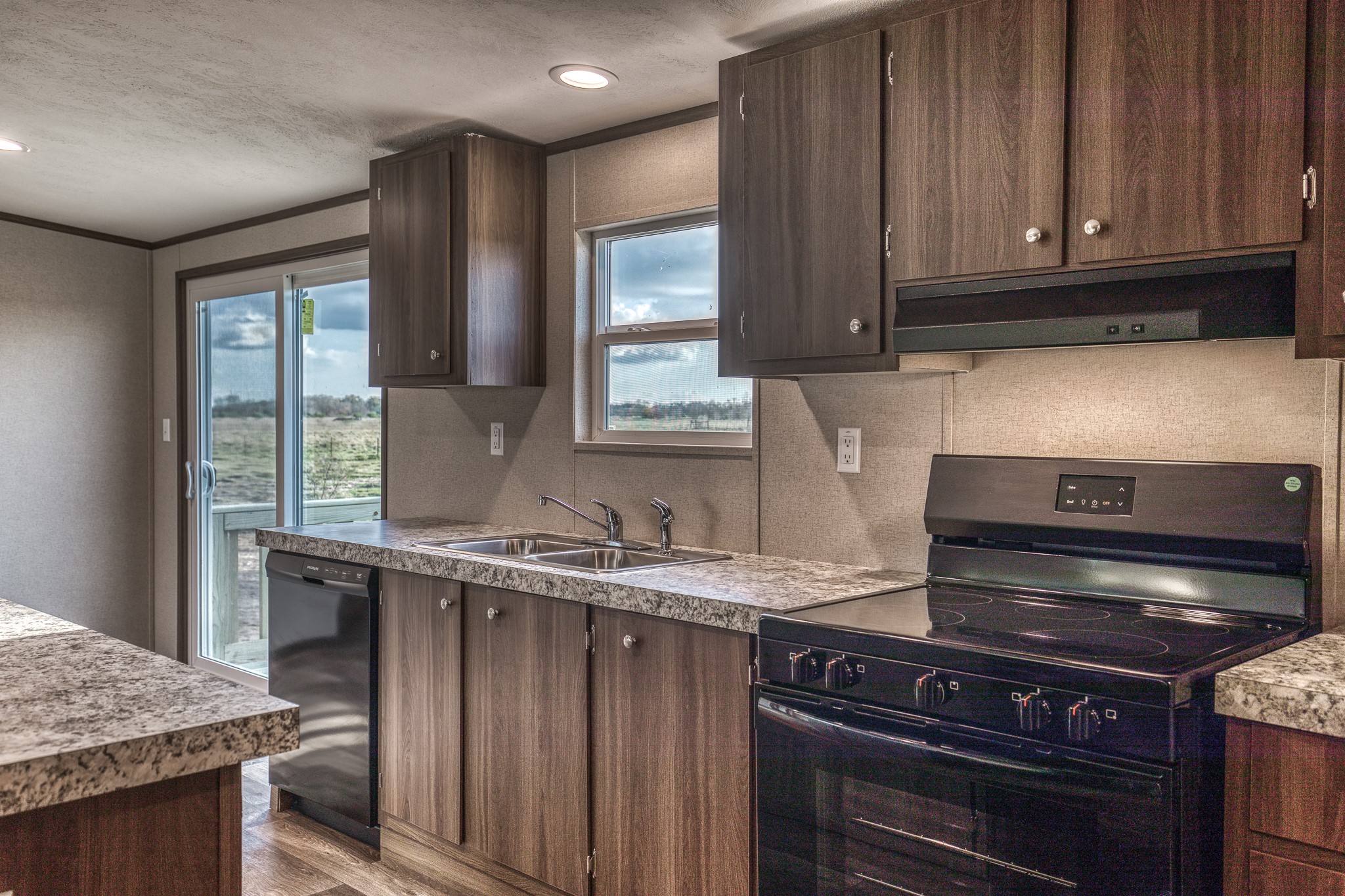 1001 Schmidt Road Waller, TX 77484 - Photo 8 of 28 a kitchen with granite countertop a stove and a sink