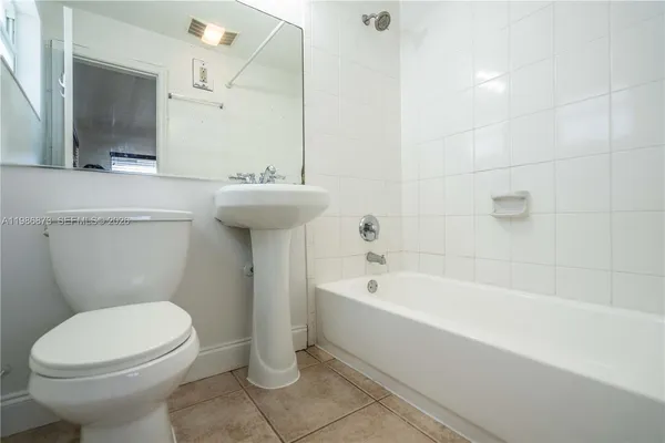 a bathroom with a sink a toilet and bathtub