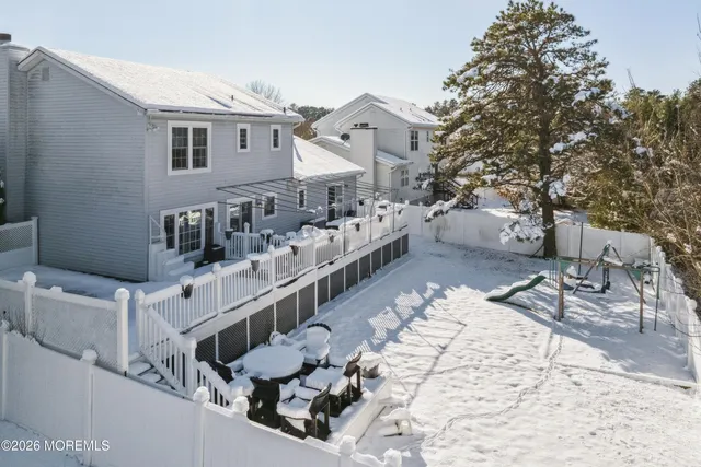 a view of residential house with wooden fence