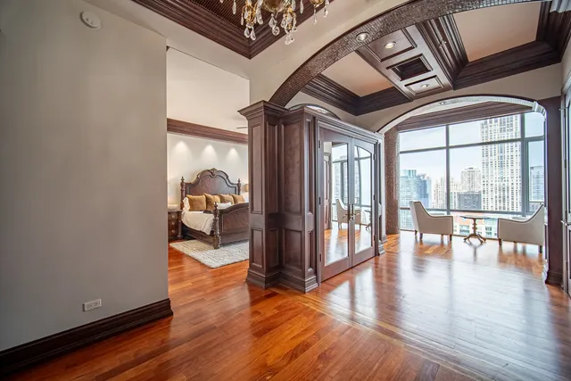 a living room with a bed furniture and a large window