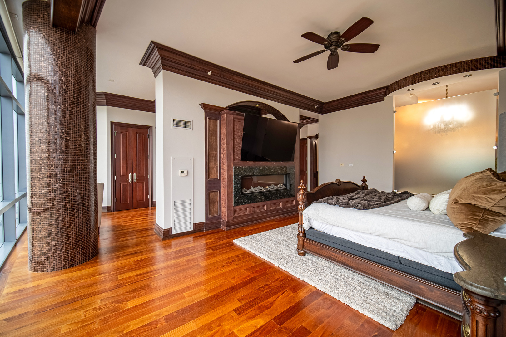 450 East Waterside Drive, Unit 3301 Chicago, IL 60601 - Photo 14 of 44 a spacious bedroom with a bed and a chandelier