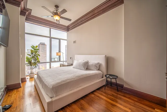 a bed room with a bed and a television