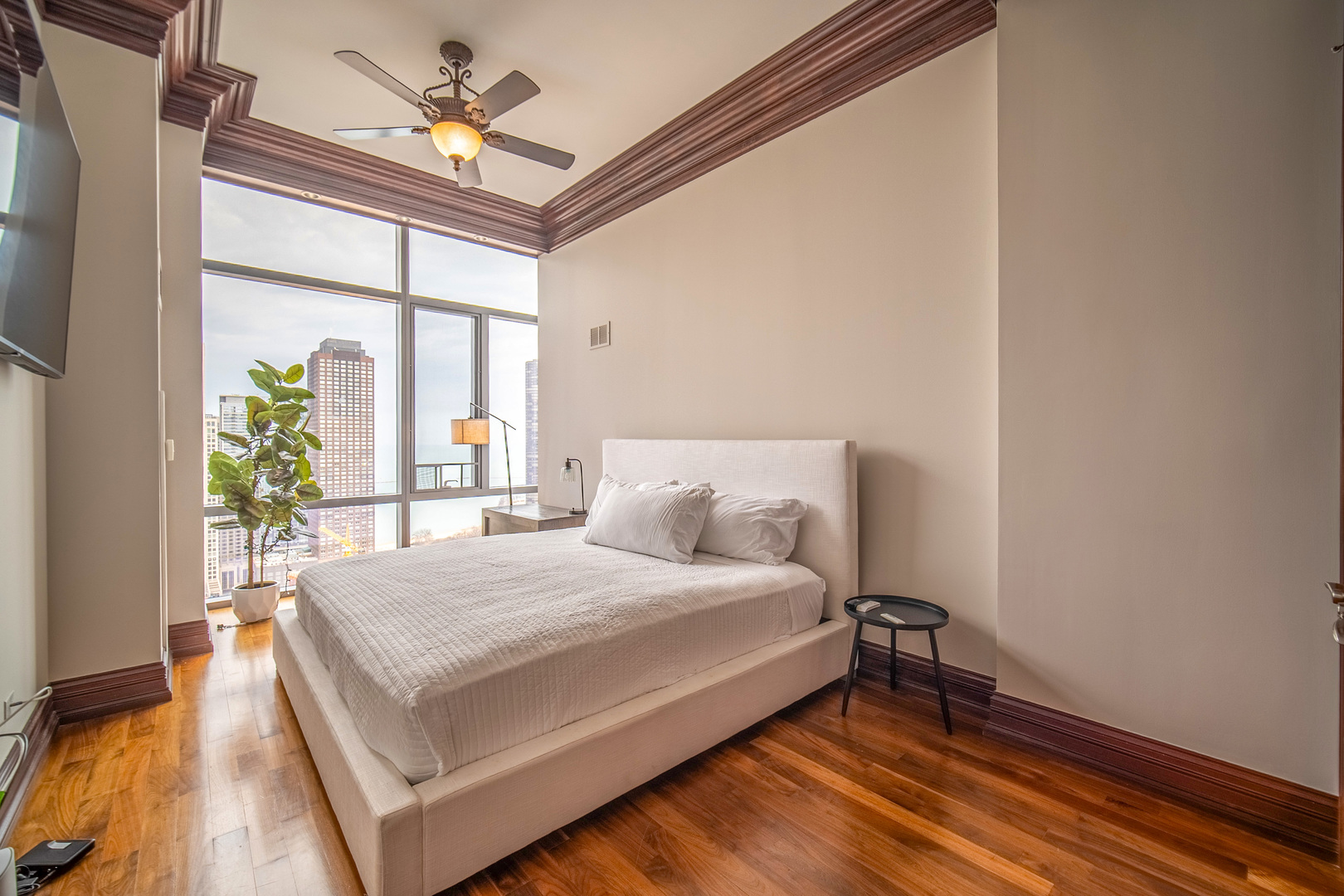 450 East Waterside Drive, Unit 3301 Chicago, IL 60601 - Photo 18 of 44 a bedroom with a bed dresser and a window