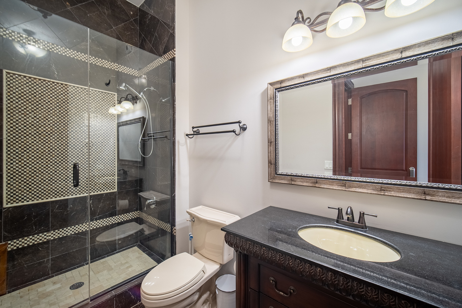450 East Waterside Drive, Unit 3301 Chicago, IL 60601 - Photo 20 of 44 a bathroom with a granite countertop toilet sink mirror and shower