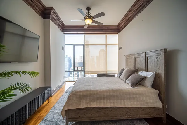 a bedroom with a bed potted plant with the outer view