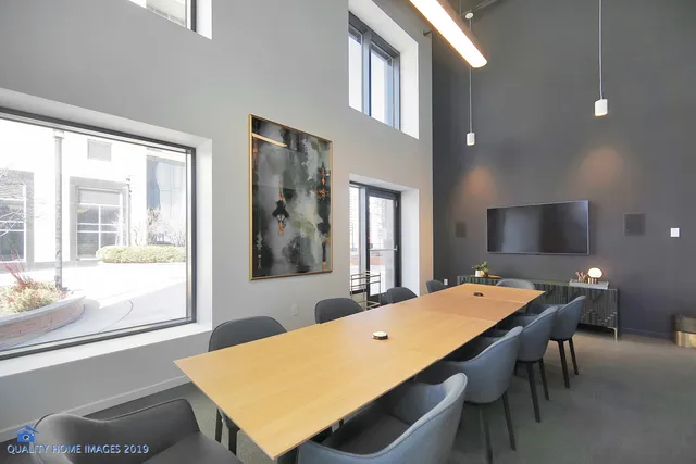 a dining hall with stainless steel appliances granite countertop a stove and a sink