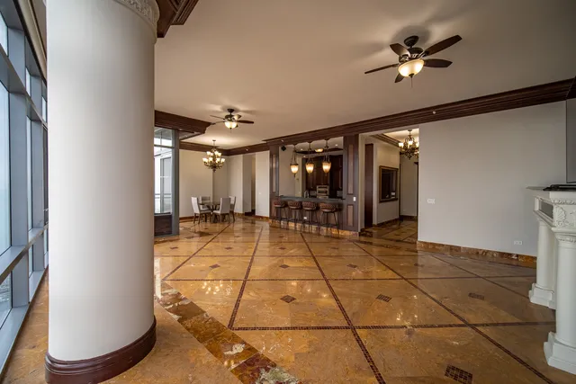 a lobby with a rug and a chandelier