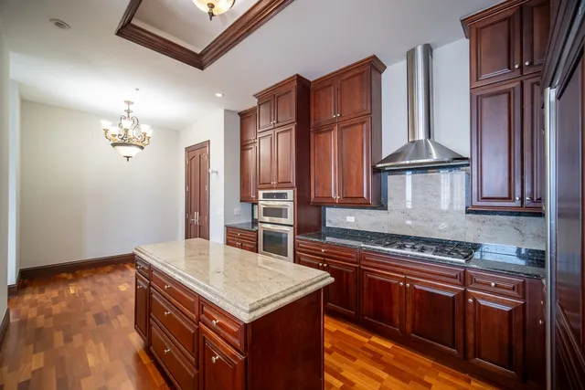 a kitchen with granite countertop a stove and a sink