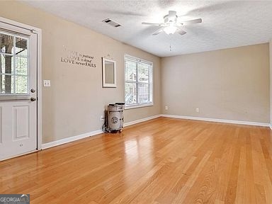 3624 White Sands Way Suwanee, GA 30024 - Photo 13 of 19 an empty room with windows and ceiling fan