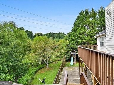 3624 White Sands Way Suwanee, GA 30024 - Photo 15 of 19 a balcony with trees in front of it