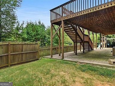 3624 White Sands Way Suwanee, GA 30024 - Photo 16 of 19 a view of deck with wooden fence and floor to ceiling window