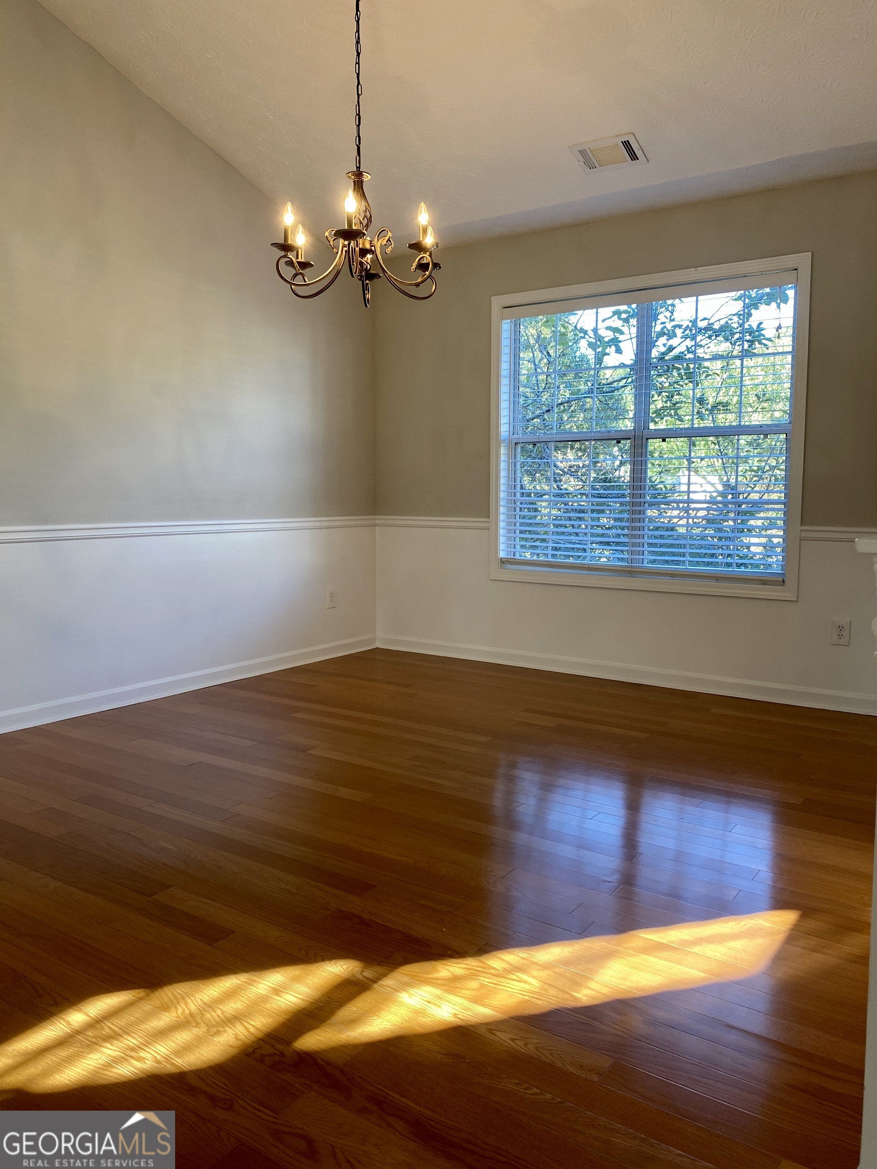 3624 White Sands Way Suwanee, GA 30024 - Photo 8 of 19 a view of a room with wooden floor and chandelier