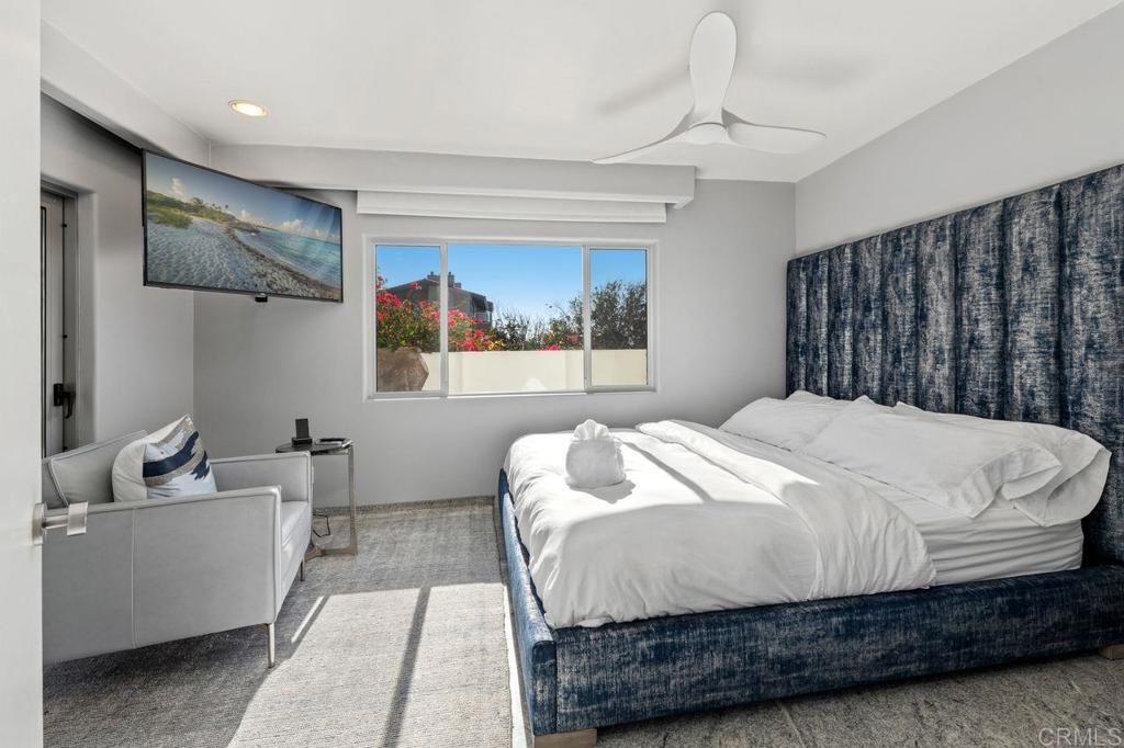 806 4th Street Encinitas, CA 92024 - Photo 22 of 32 a bedroom with a large bed and a chandelier