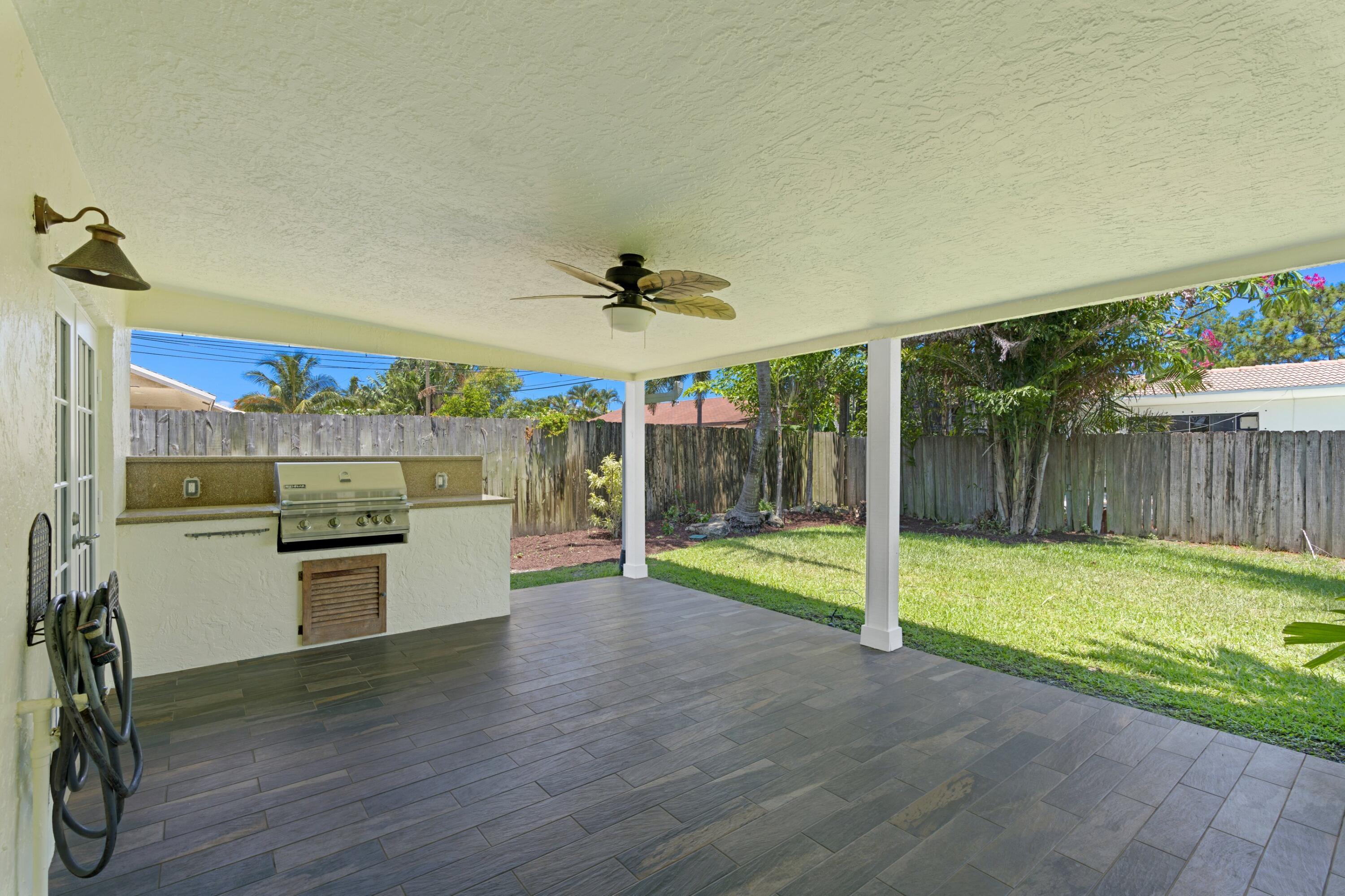 263 Northeast 24th Court Boca Raton, FL 33431 - Photo 15 of 29 a view of a livingroom with a furniture wooden floor and a yard
