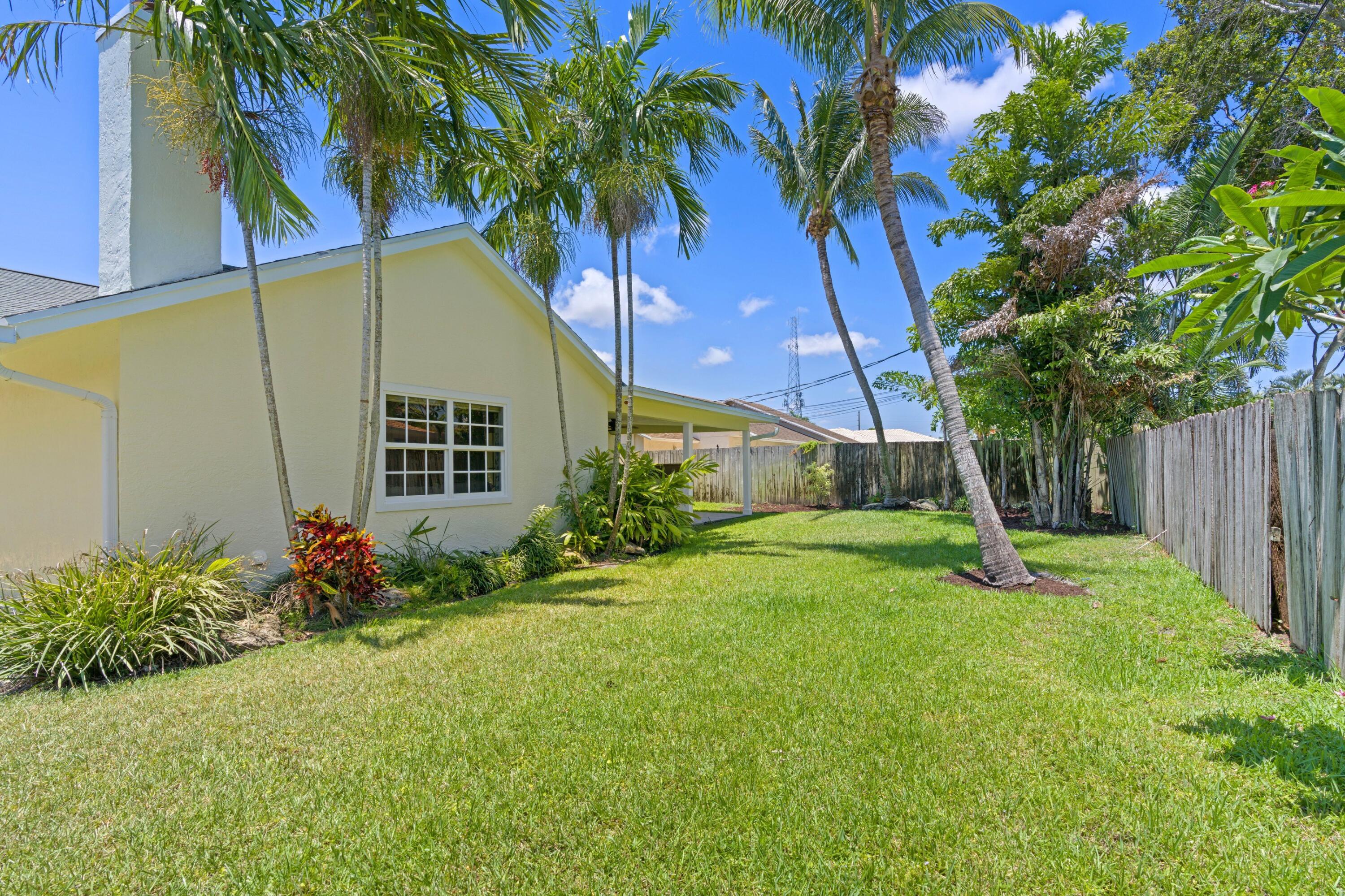 263 Northeast 24th Court Boca Raton, FL 33431 - Photo 16 of 29 a backyard of a house with barbeque oven table and chairs