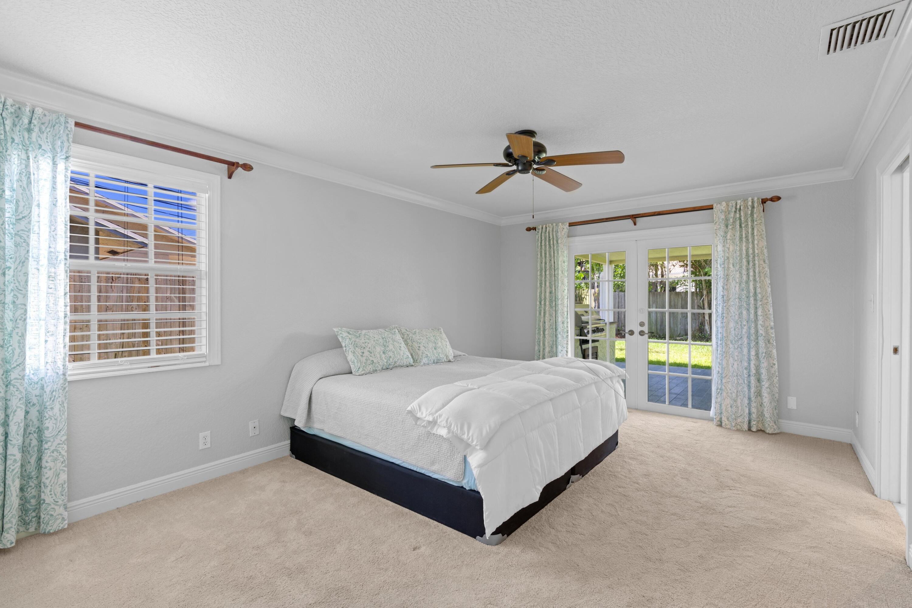 263 Northeast 24th Court Boca Raton, FL 33431 - Photo 7 of 29 a spacious bedroom with a bed and a window