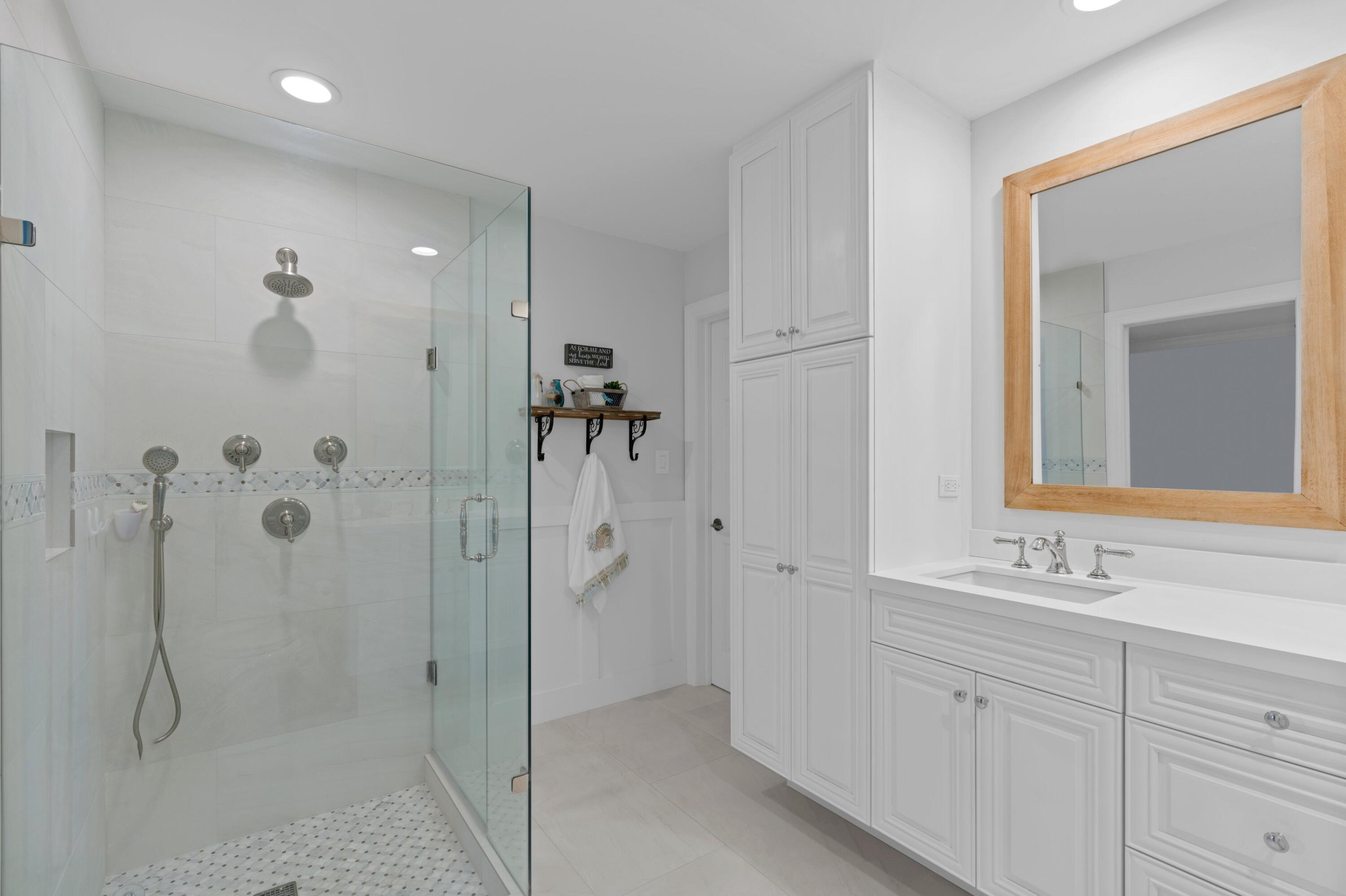 263 Northeast 24th Court Boca Raton, FL 33431 - Photo 9 of 29 a bathroom with a shower sink and mirror