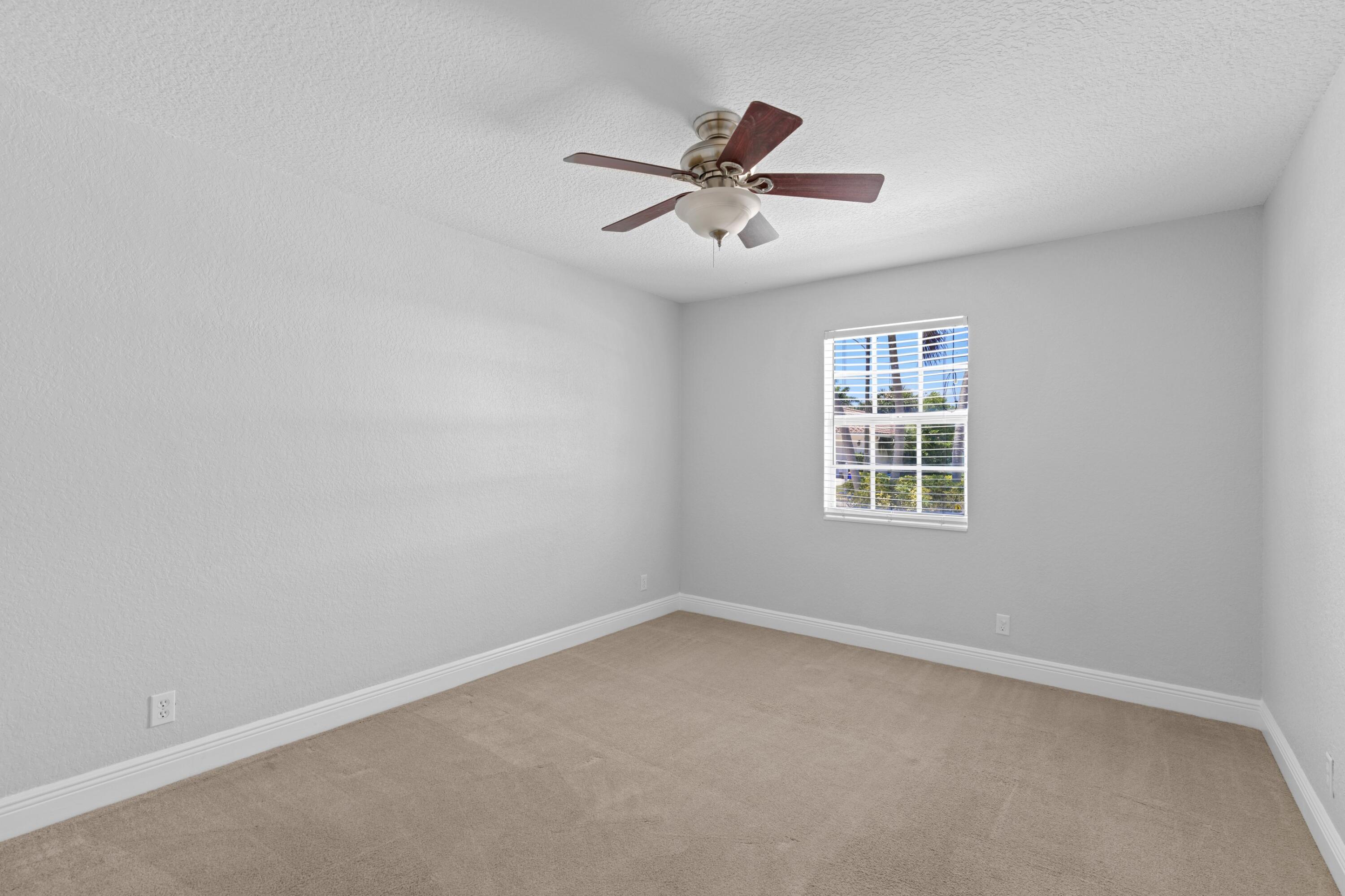 263 Northeast 24th Court Boca Raton, FL 33431 - Photo 10 of 29 an empty room with a window and ceiling fan