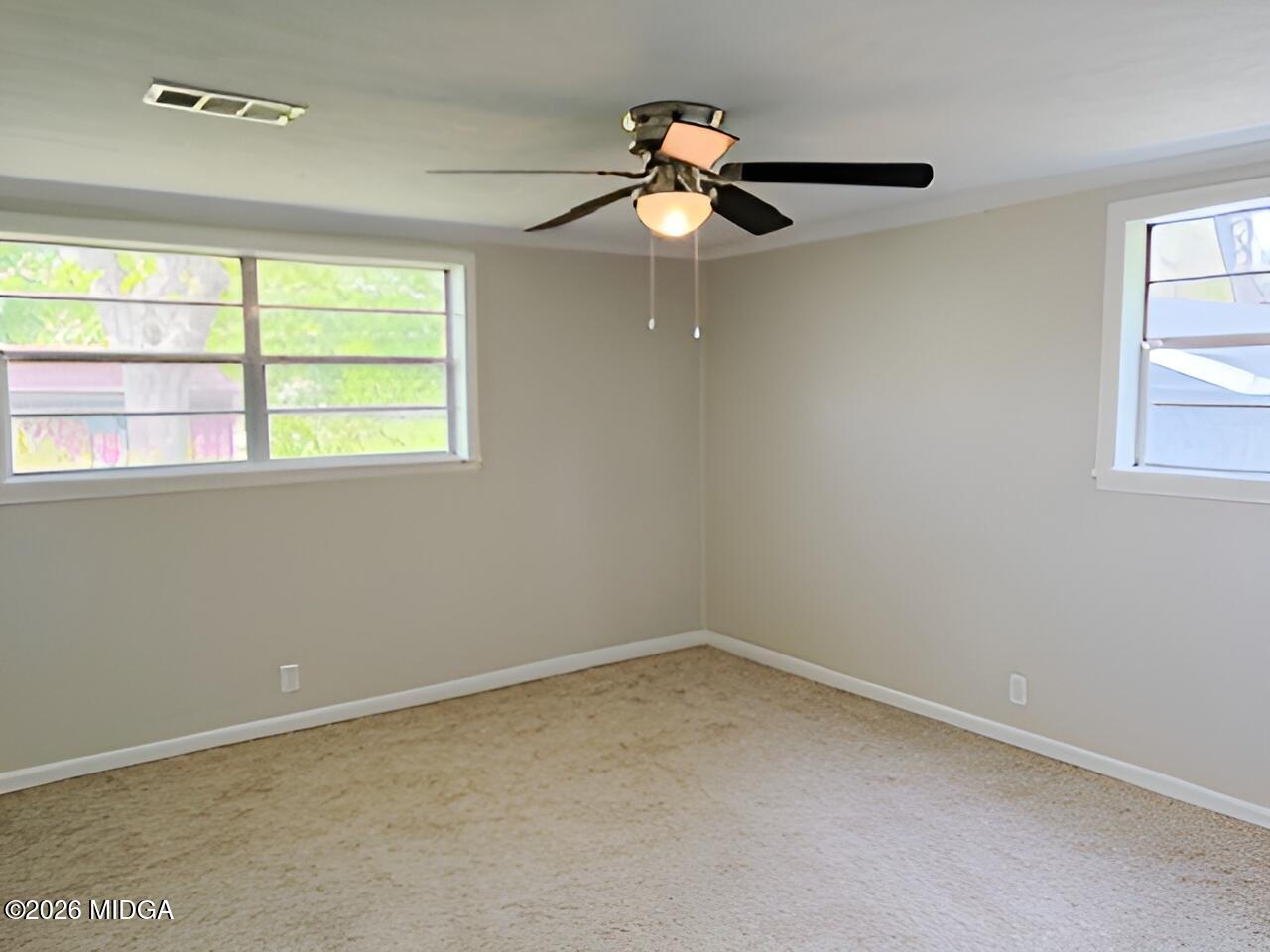868 Mac Thompson Road Cochran, GA 31014 - Photo 23 of 31 an empty room with a window and a fan