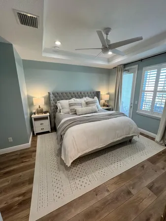 a bedroom with a bed and large mirror