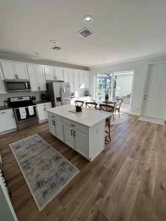a large kitchen with a table and chairs in it