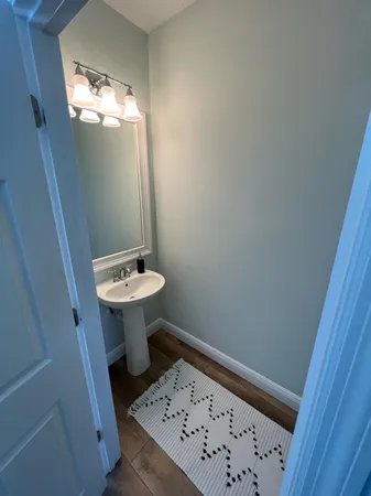 a bathroom with a sink a toilet and mirror