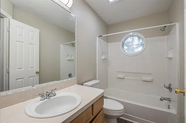 a bathroom with a sink toilet and a mirror