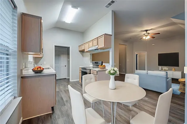 a view of a dining room with furniture and a chandelier