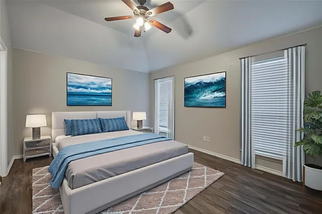 a bedroom with a large bed and a chandelier