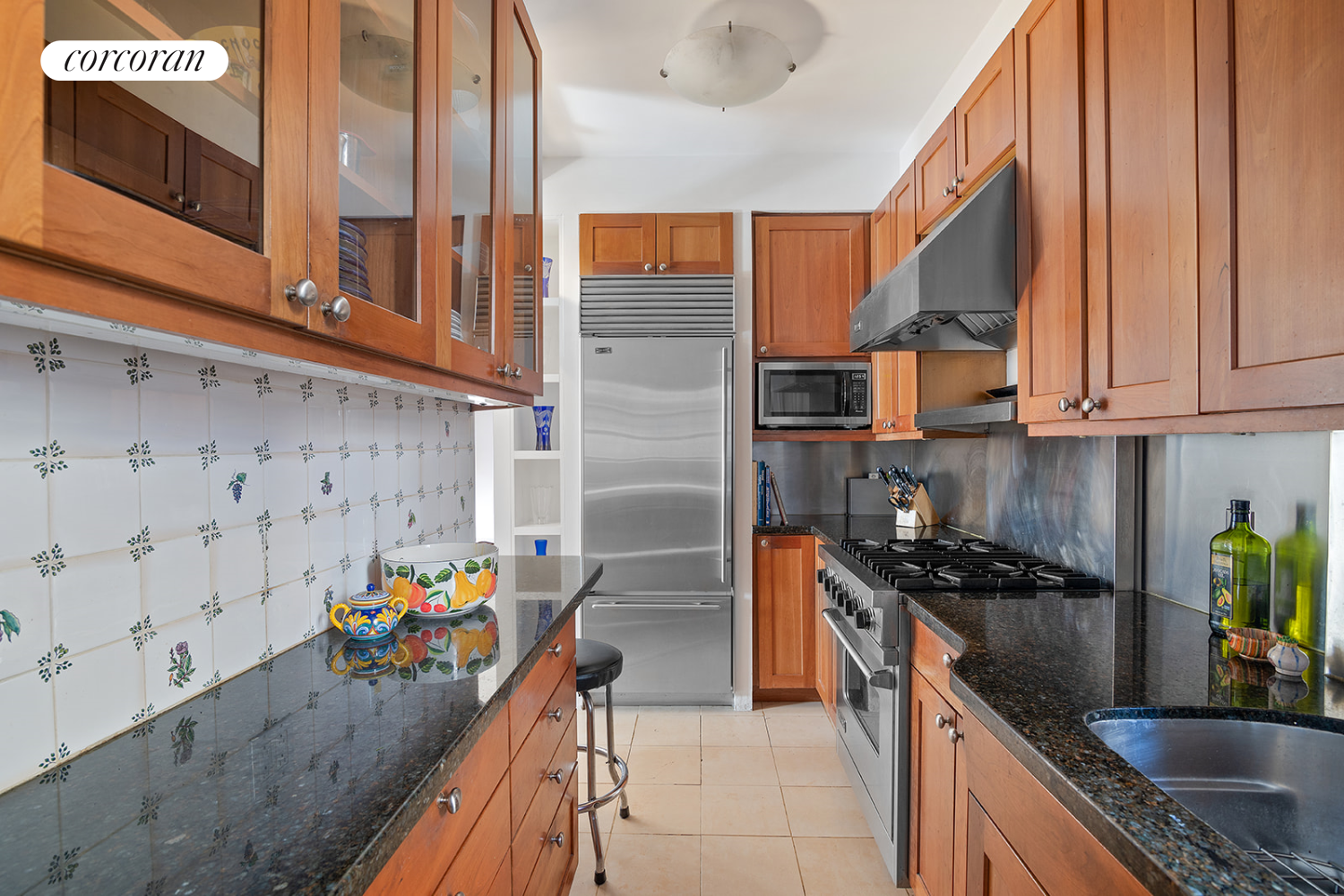 18 West 70th Street, Unit 8C Manhattan, NY 10023 - Photo 9 of 26 a kitchen with stainless steel appliances granite countertop a sink stove and cabinets