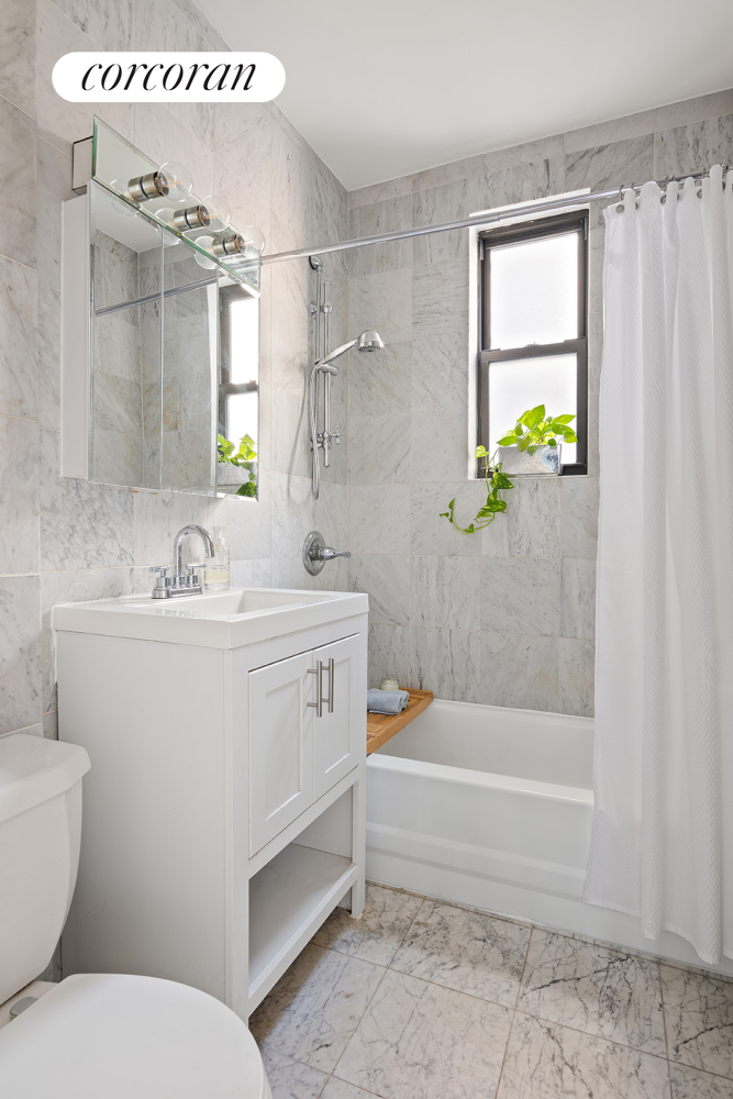 18 West 70th Street, Unit 8C Manhattan, NY 10023 - Photo 10 of 26 a bathroom with a sink toilet and shower