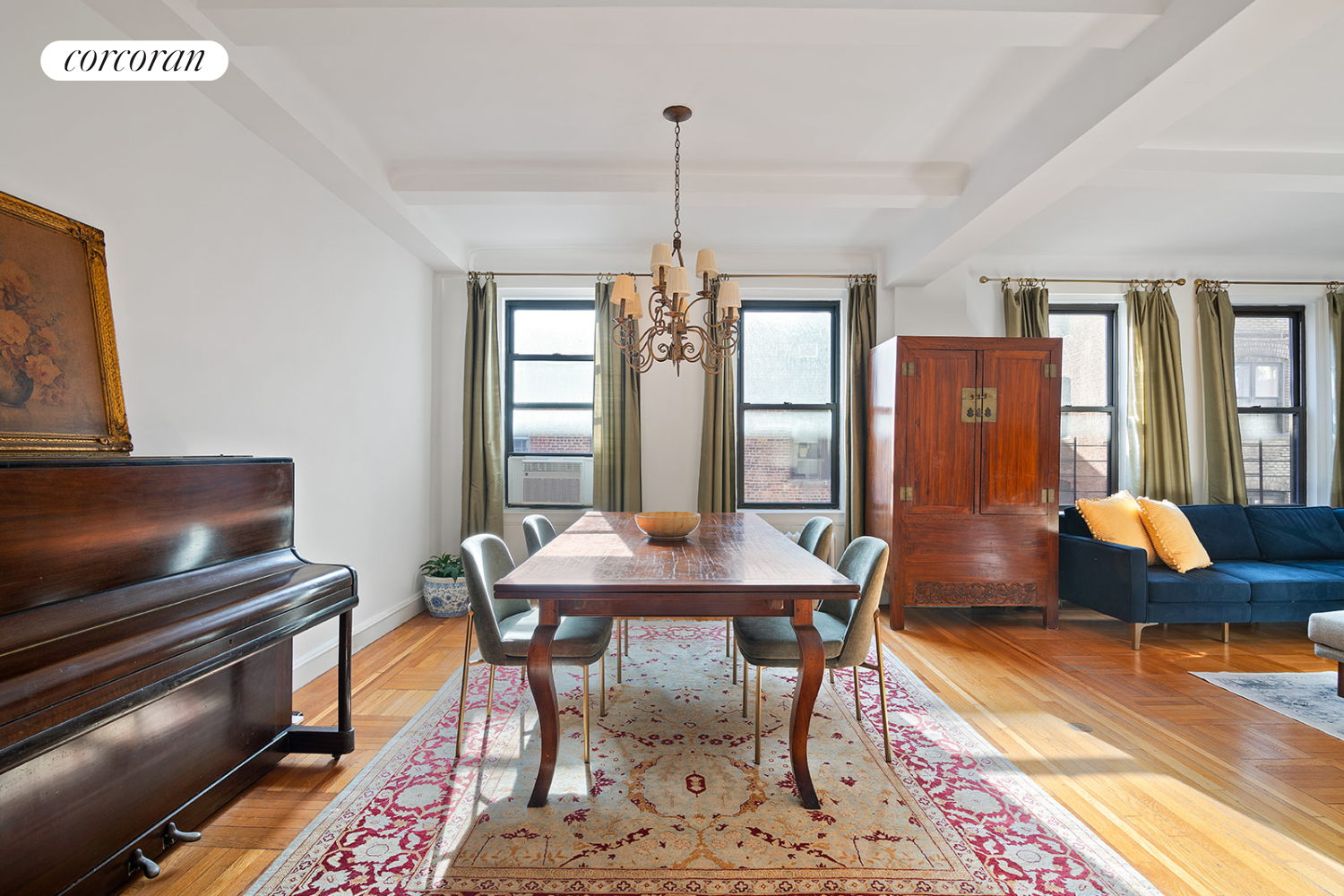 18 West 70th Street, Unit 8C Manhattan, NY 10023 - Photo 12 of 26 a dining room with furniture a rug and a chandelier