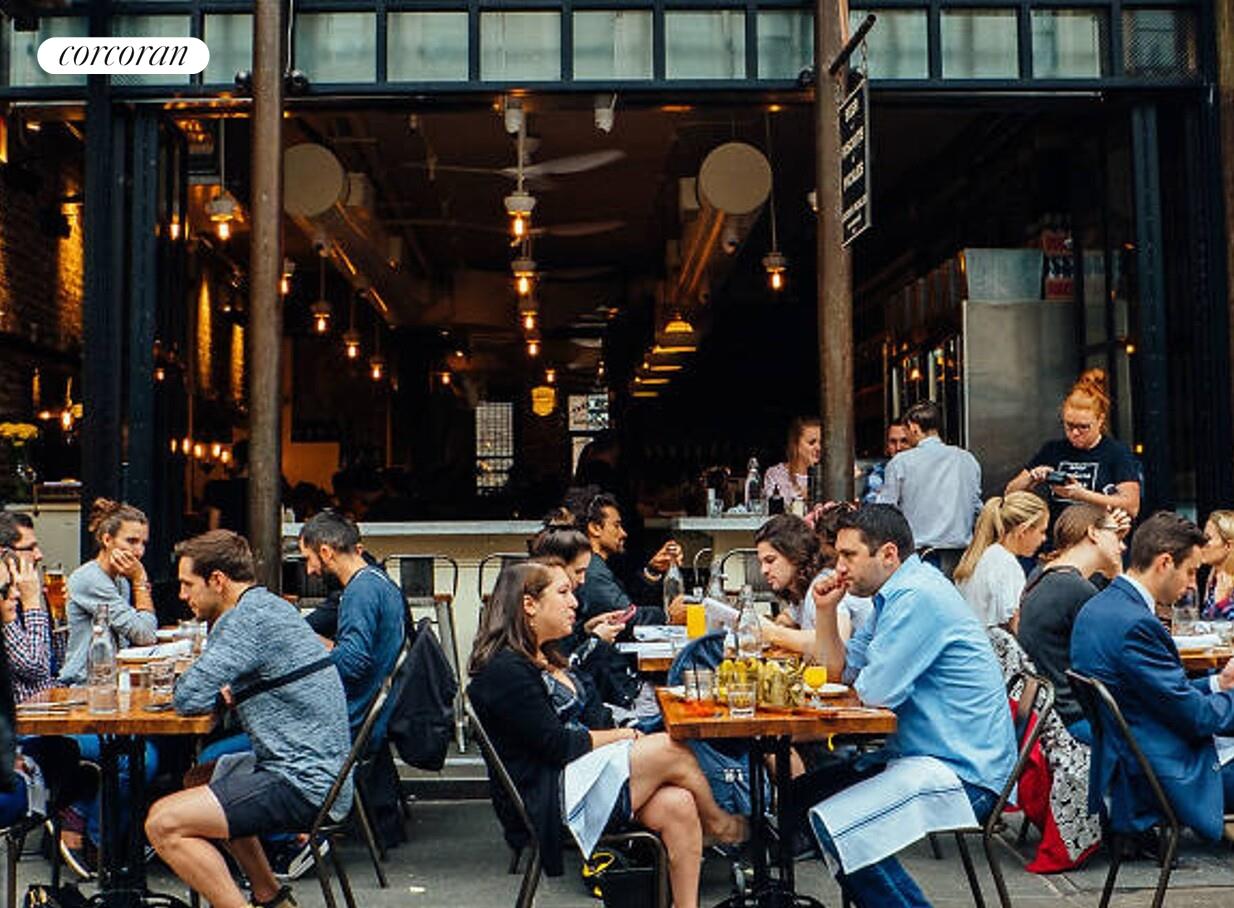 18 West 70th Street, Unit 8C Manhattan, NY 10023 - Photo 19 of 26 a group of people sitting outside of a building